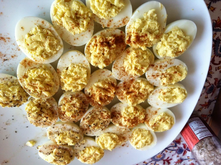 eggs cut in half with spices scattered all over