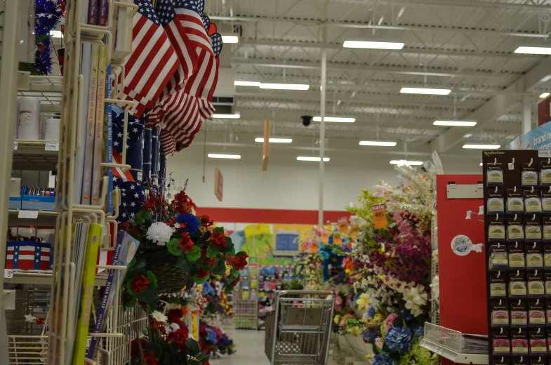 a shop with american flags and flowers hanging from the ceiling