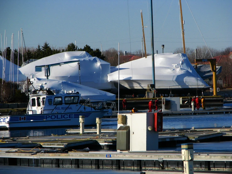 some large ships parked in the water near a building