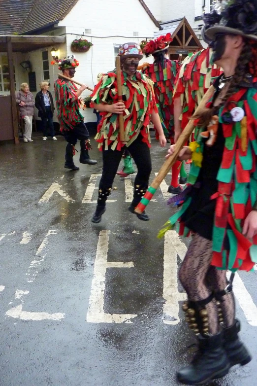 a number of people in costume and with umbrellas