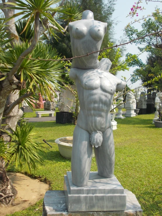 a statue of a male standing on his back with his hand on his chest