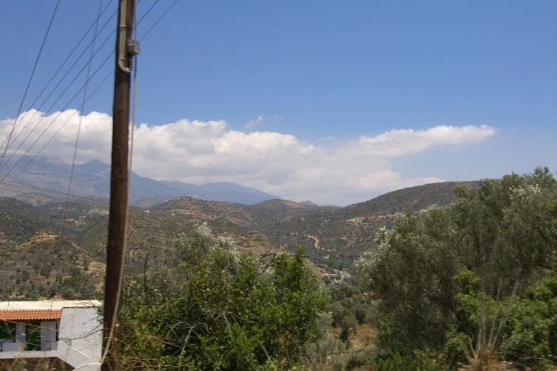 the mountains look to be covered with clouds in the sky