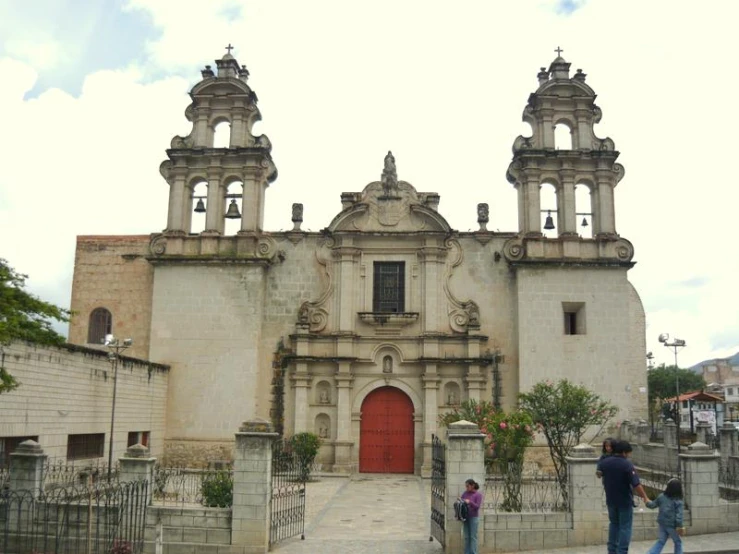 people standing in front of an old building