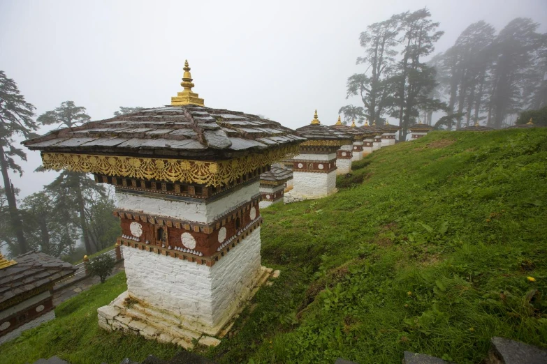 a couple of pavilions on a hillside with many fog