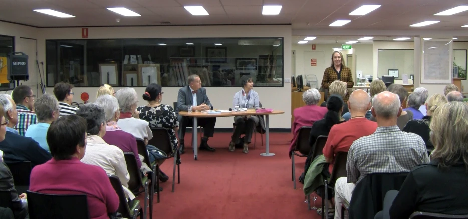 an audience watching a person speaking at an event