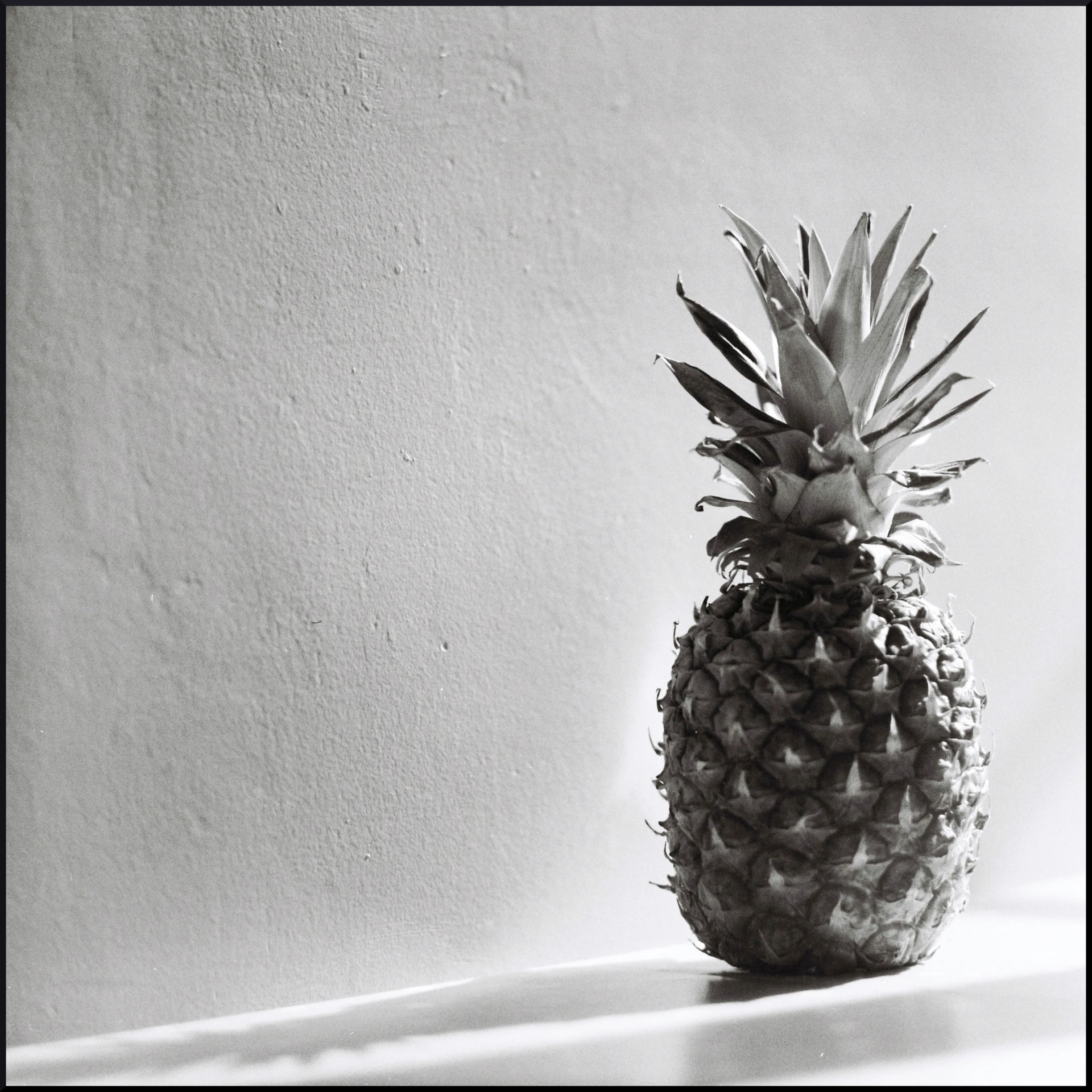 a pineapple standing upright on a table