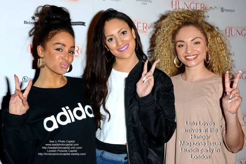 three beautiful women making the v signs with their fingers