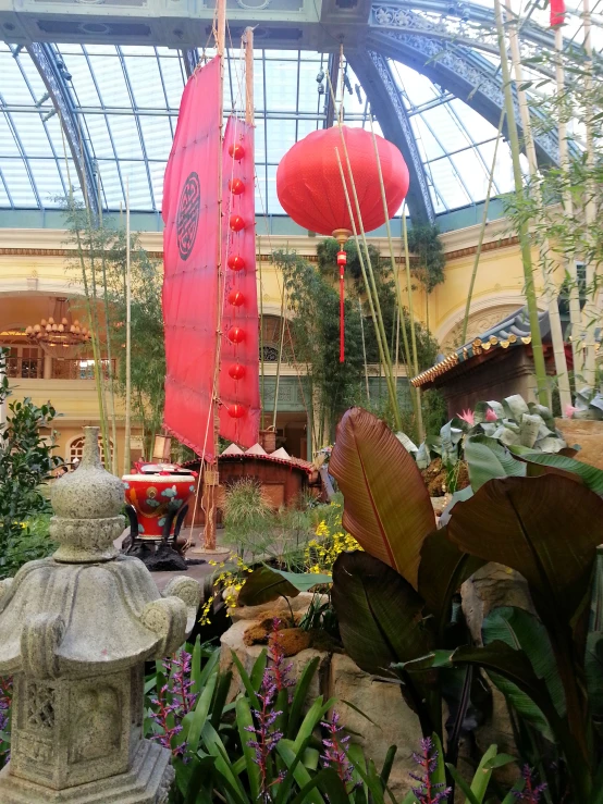 a red boat in the middle of flowers