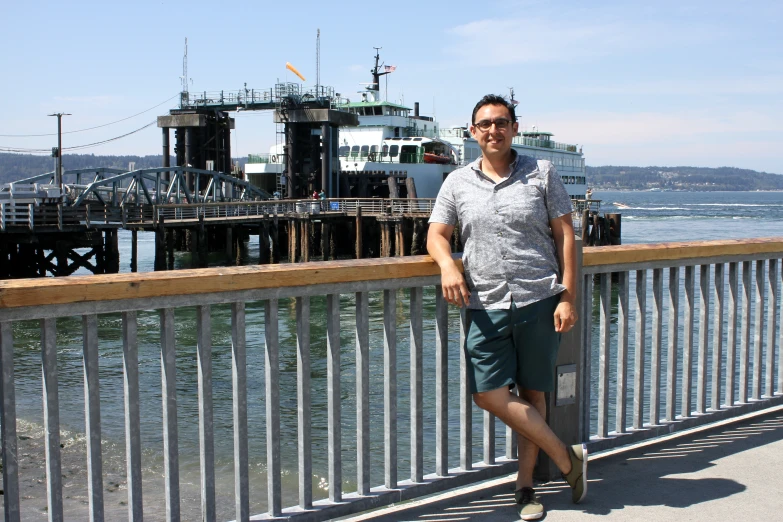 the man stands on a bridge over the water