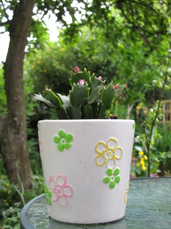 a large pot filled with plants on top of a table