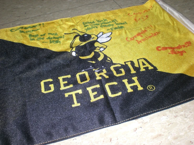 an old yellow and black cloth with a logo