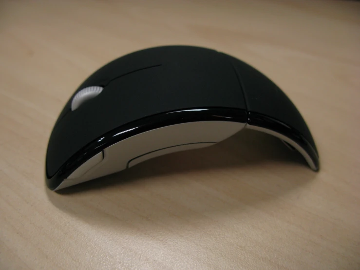 a black computer mouse sitting on a desk