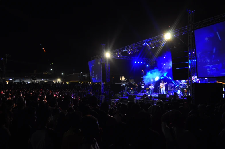 a concert is being held at the stadium with blue light and people watching