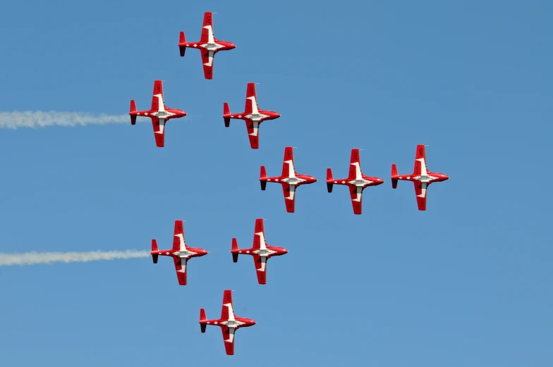 five jets are flying in the sky with their smoke trailing