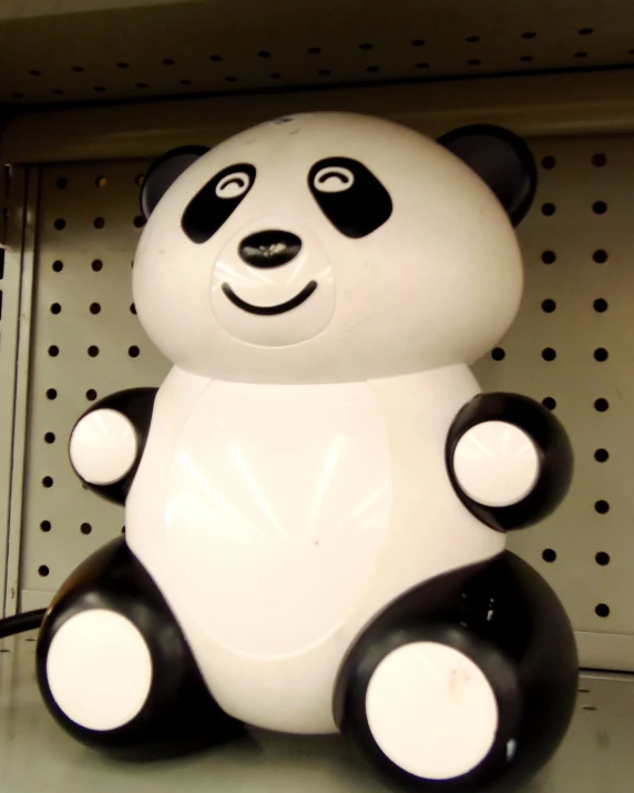 a panda bear sitting in the corner of a store