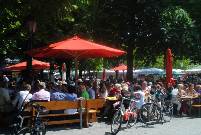 many people are at an outdoor cafe table