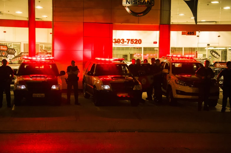 emergency vehicles and people lined up in front of a walmart