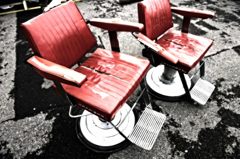 two red chairs on top of a black floor