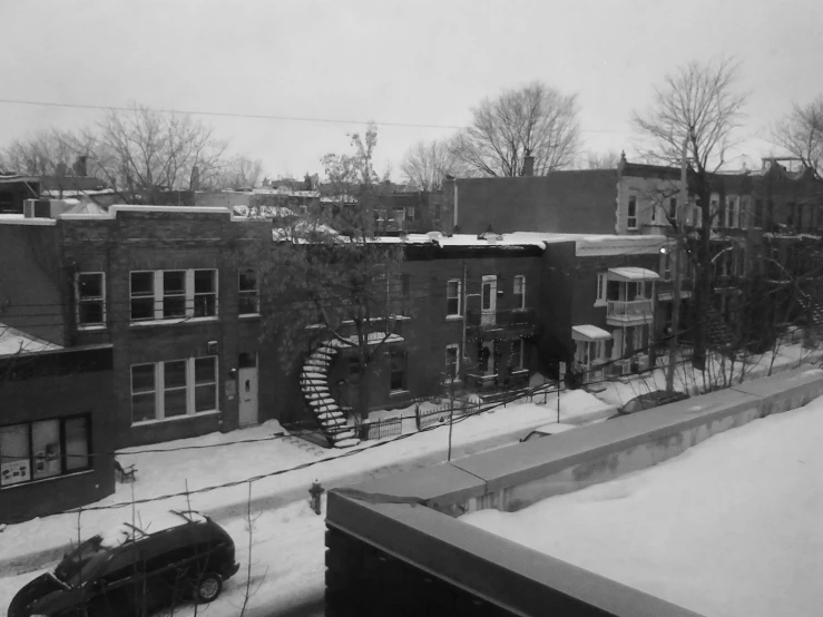 snow covers buildings and car parks in a winter scene