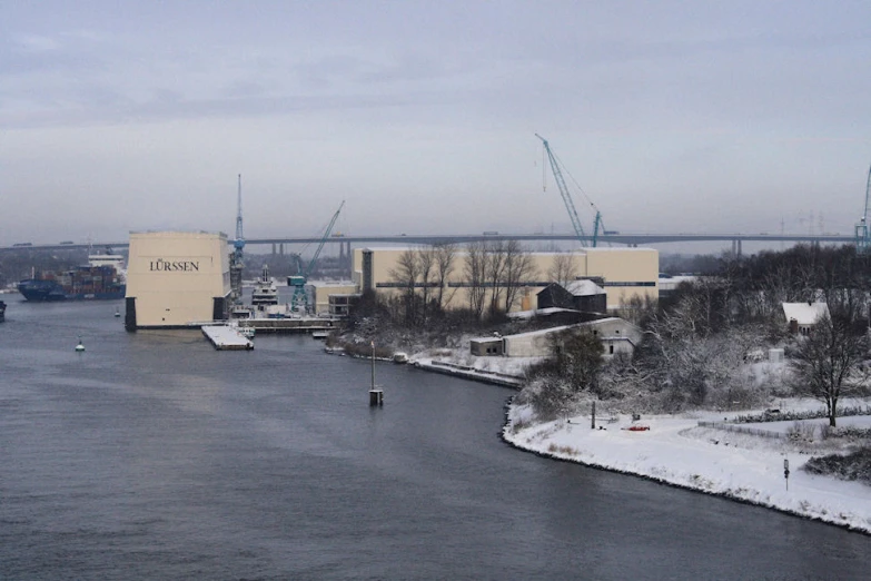 the city next to the water is covered with snow