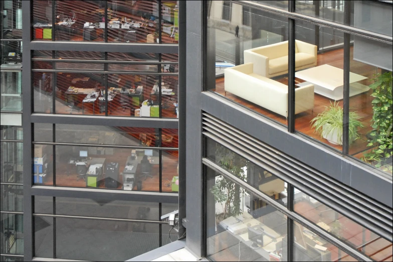 a glass walled room is shown with an indoor seating area