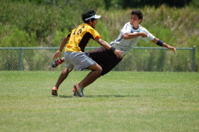 two young men playing a game of ultimate frisbee