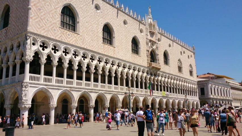 a group of people walk in front of a building