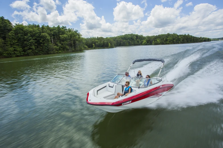 people on a red and white boat going down the river