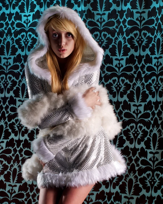 a woman wearing a fur lined coat with fur trim