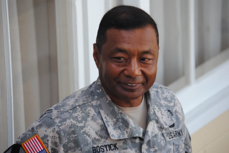 an older military man in uniform looks at the camera