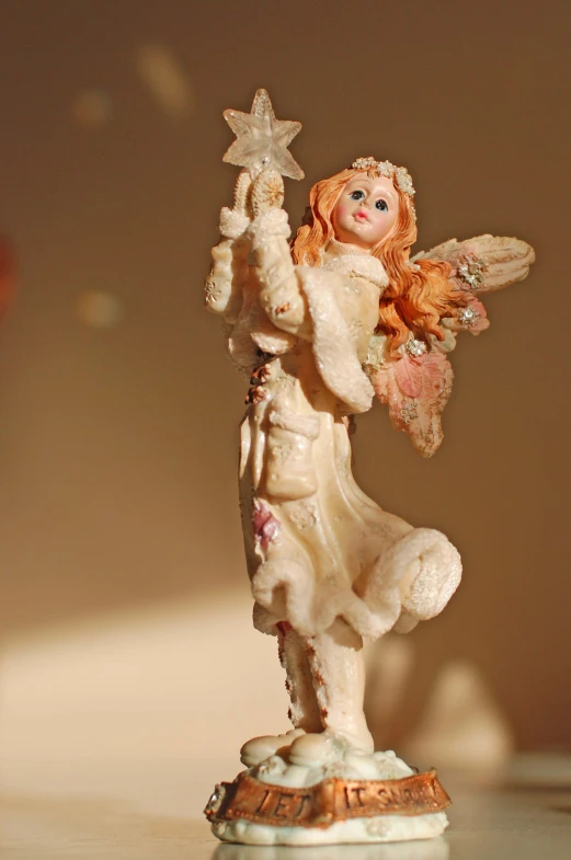 a close up s of a toy angel with an orange hair