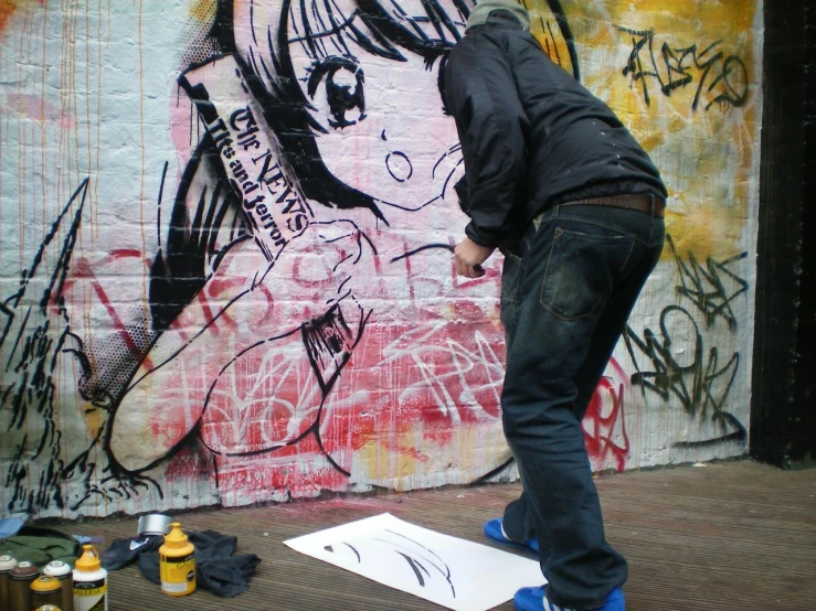 a person on a skate board next to graffiti