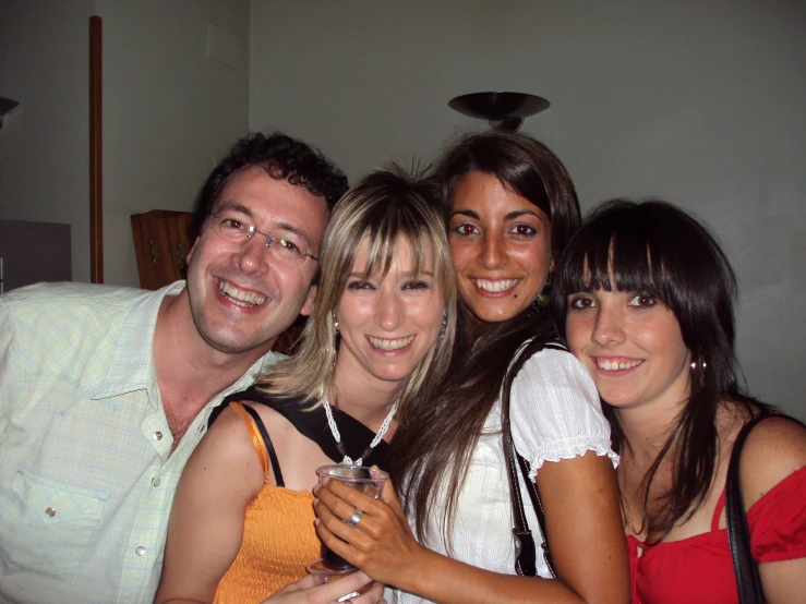 four people are posed smiling and smiling for the camera