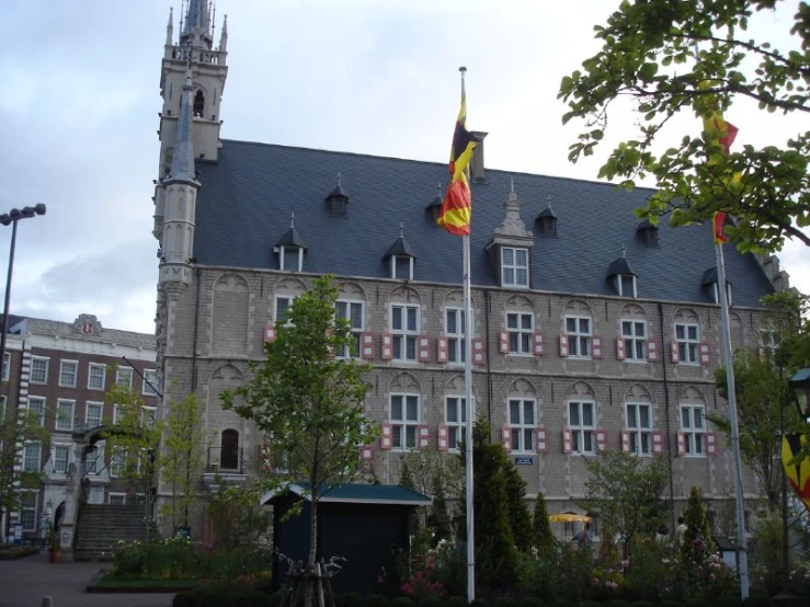 a large building with flags flying in front