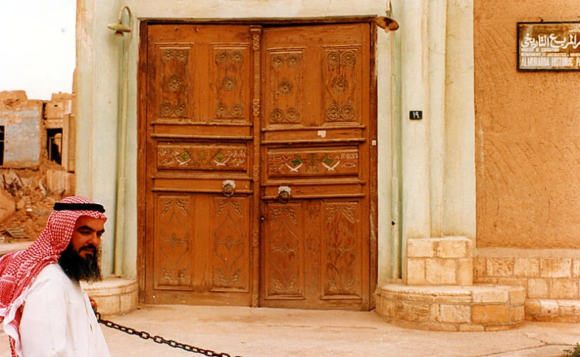 a man is walking outside of an old building