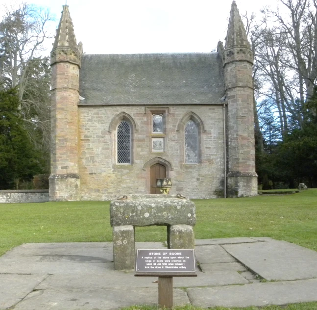 a small statue of a stone bench with a monument on the ground