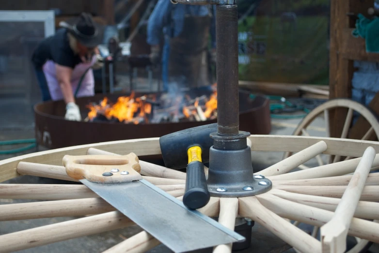 a person is working on some wood in a fire pit