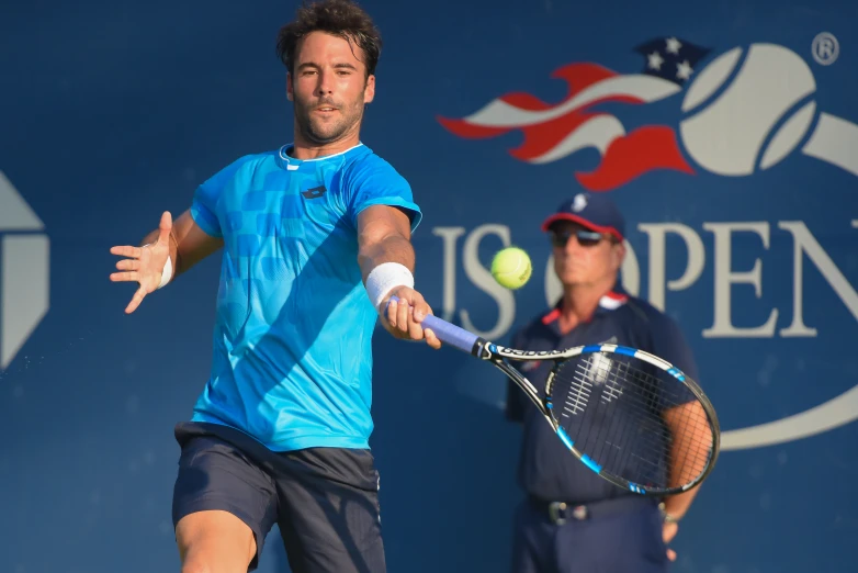 a man swinging at a tennis ball on a tennis court