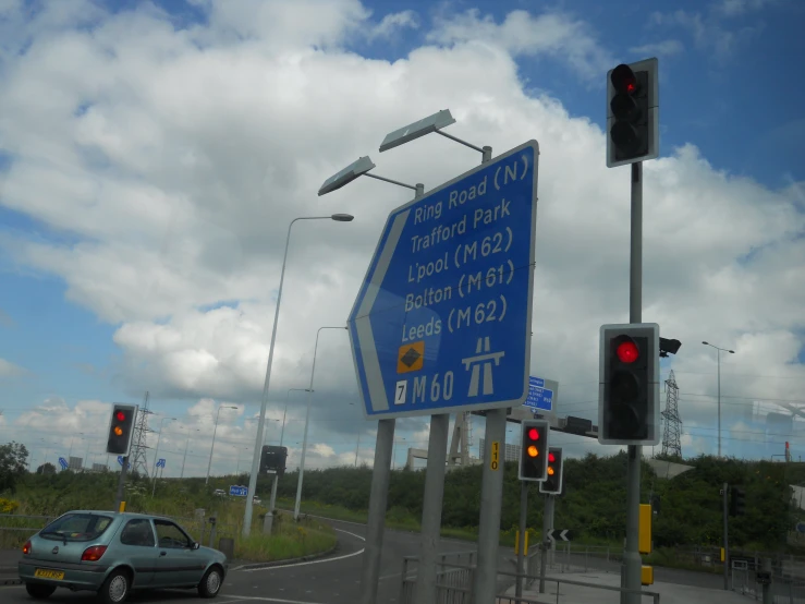 an intersection with blue signs and traffic lights