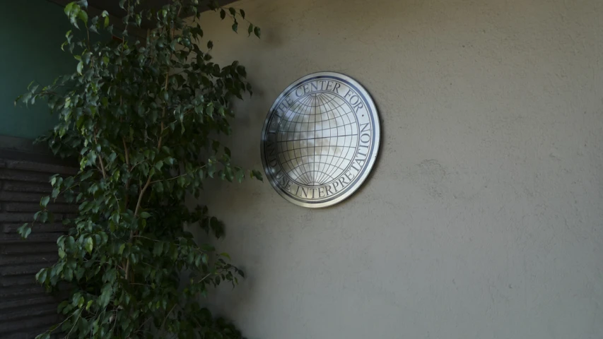a wall mounted satellite is attached to a stucco wall