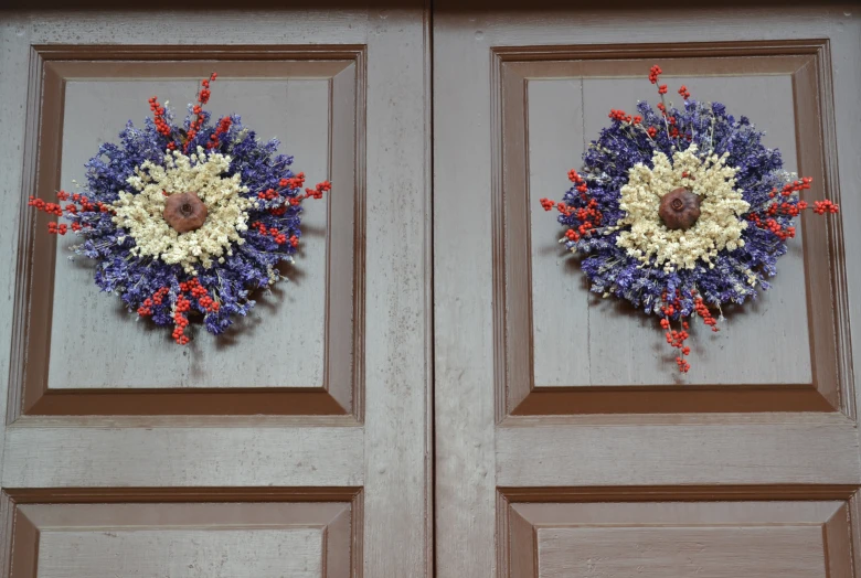 two large doors decorated with wreaths and flowers