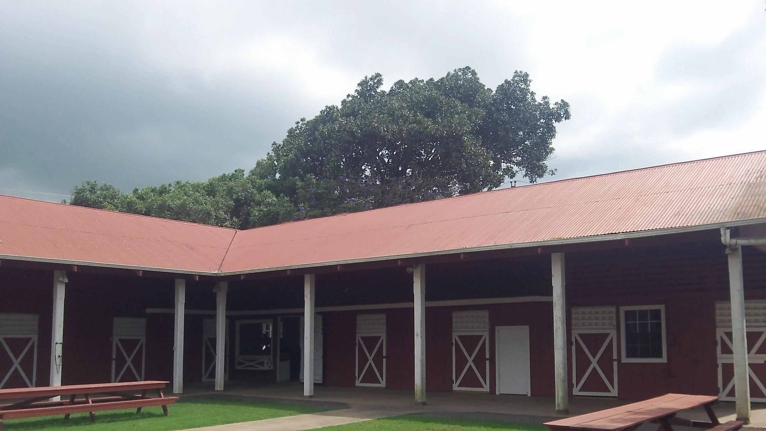 a building with a red roof and white doors