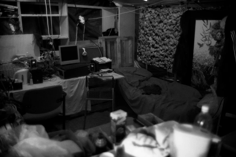 black and white image of a very messy room