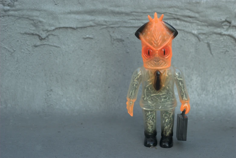 a toy figurine is dressed as an alien