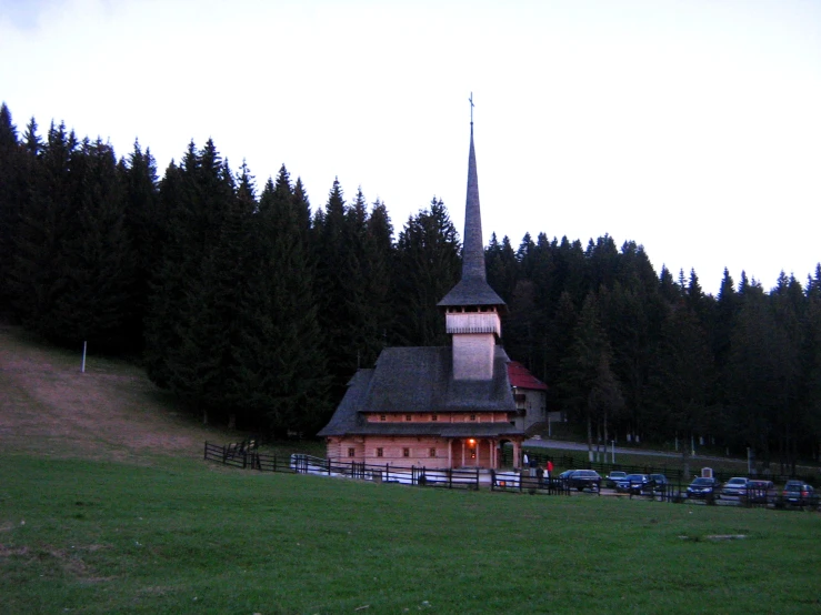 a red church sitting on the side of a road