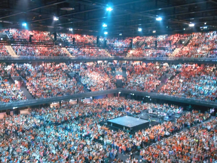 a very large crowd inside a stadium filled with people