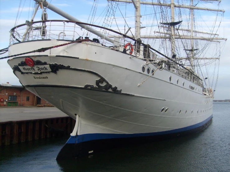 a large white boat with a huge bow is docked