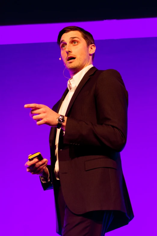 a man speaking with a microphone in his hand