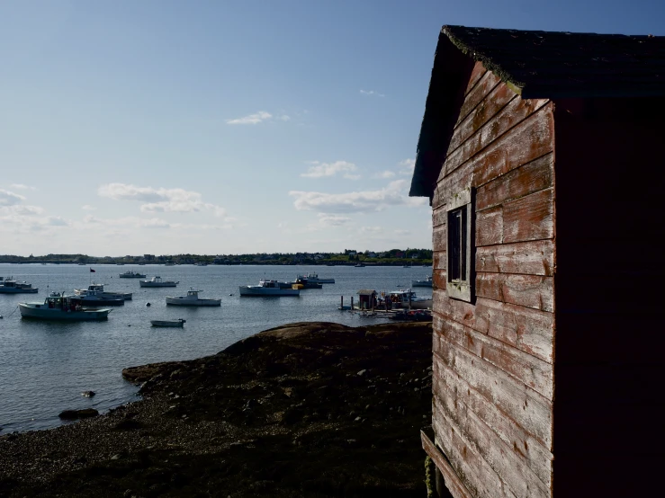 a small building on the shore by a body of water