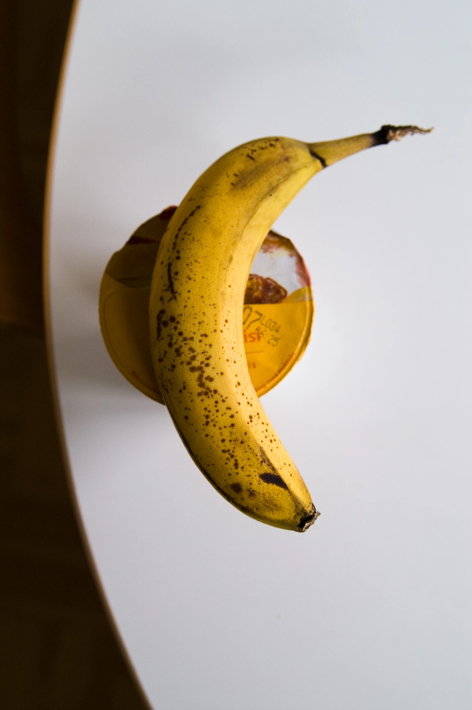 a ripe banana sitting on a white counter top